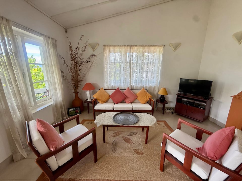 Wooden sofas and colourful cushions in the lounge